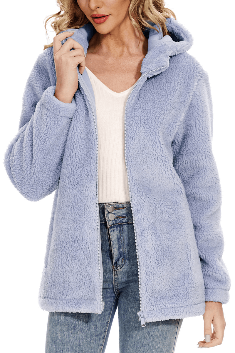 Woman modeling a stylish fluffy blue jacket with hood and zipper, perfect for fashion and warmth. SF0905 polyester jacket.